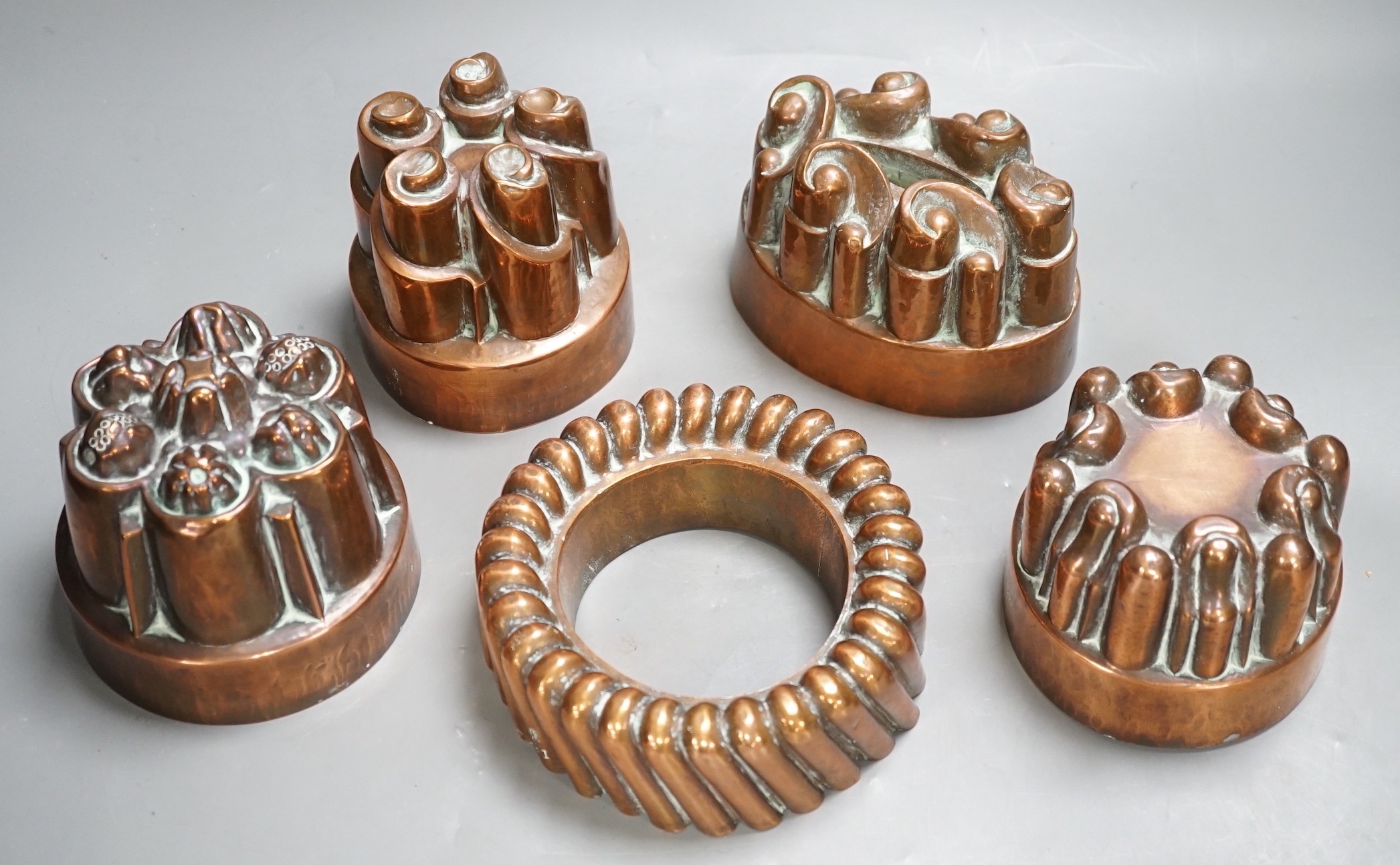 Five Victorian Benham & Froud copper jelly moulds, tallest 12cms